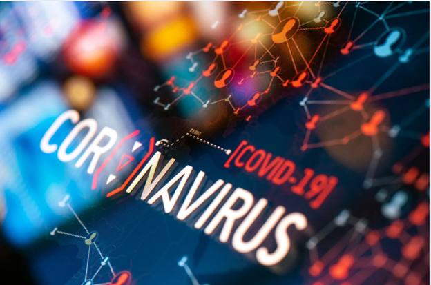 The image shows a close-up view of a digital display with the word COVID prominently displayed, along with various other text elements related to COVID-19 statistics or information, set against a background that appears to be an abstract pattern with nodes and connections resembling a network.