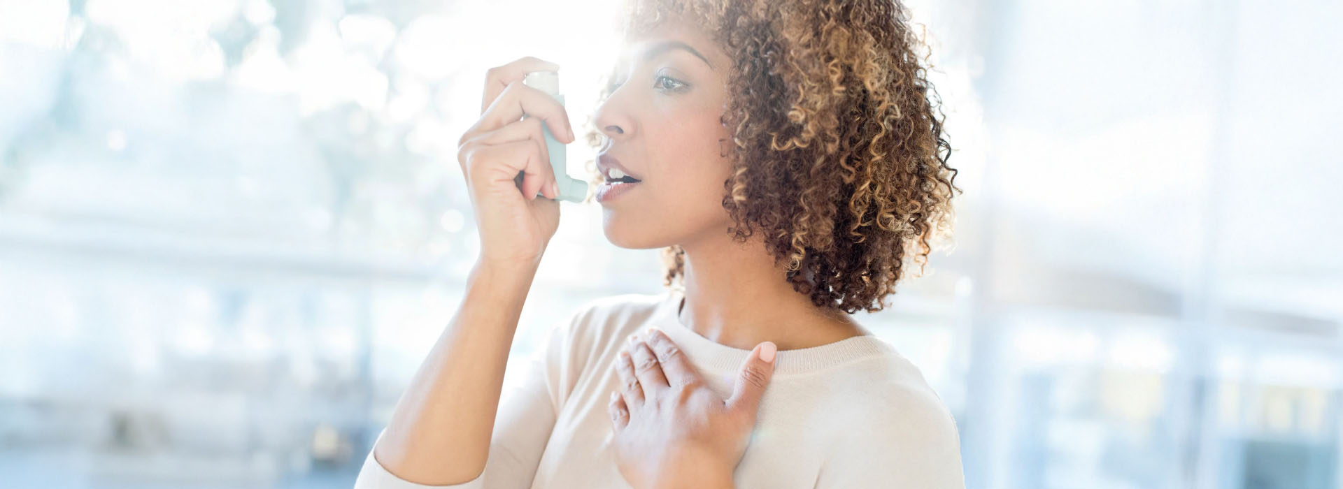 A woman applying makeup with her hands.